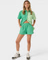 Woman wearing a green outfit on a white background