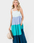 Woman wearing a color-blocked dress with a white, blue, and teal design on a plain background.