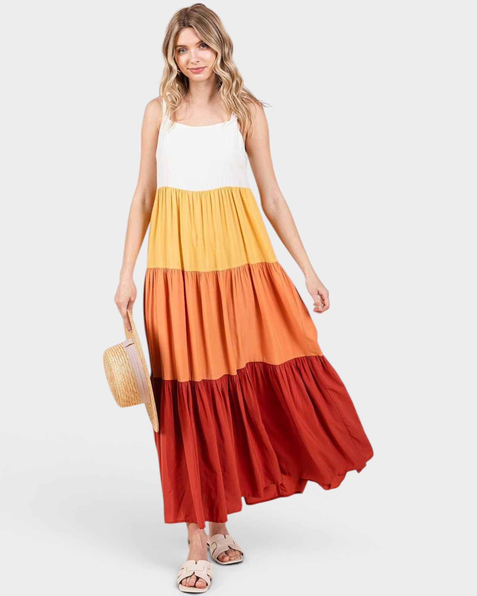 Woman wearing a multicolored dress with a white top and red bottom on a white background