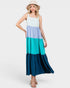 Woman wearing a color-blocked dress with a white, blue, and teal design on a white background