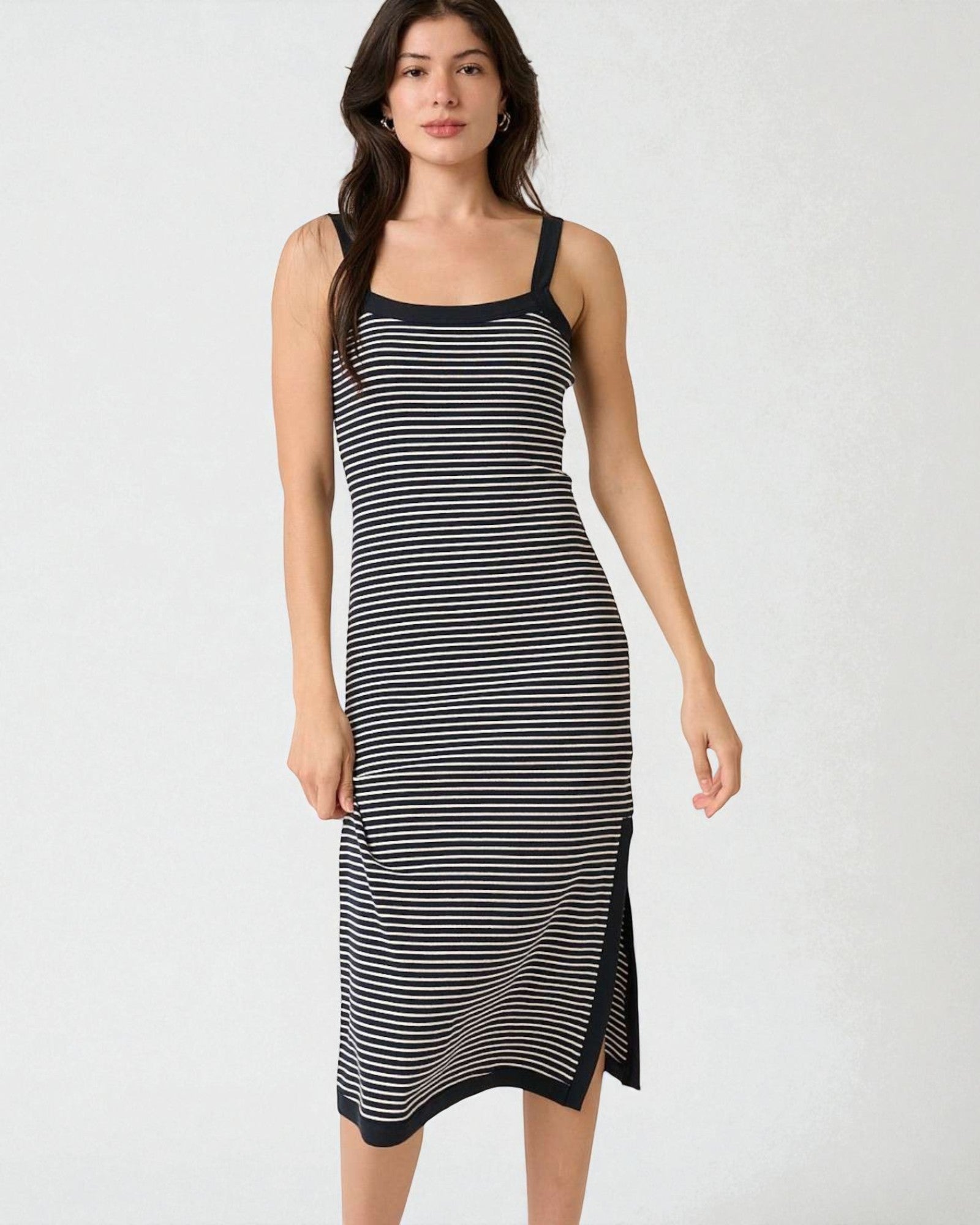 Woman wearing a black and white striped dress on a white background