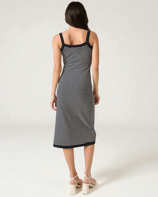 Woman wearing a black and white striped dress on a white background