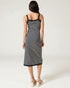 Woman wearing a black and white striped dress on a white background