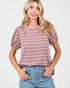 Woman wearing a striped pink and white top with puffed sleeves on a white background