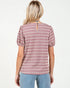 Woman wearing a pink and white striped blouse with puff sleeves on a white background