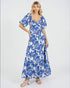 Woman wearing a blue floral dress on a white background