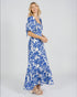 Woman wearing a blue floral dress on a white background