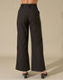 Black wide-leg pants worn by a person on a beige background