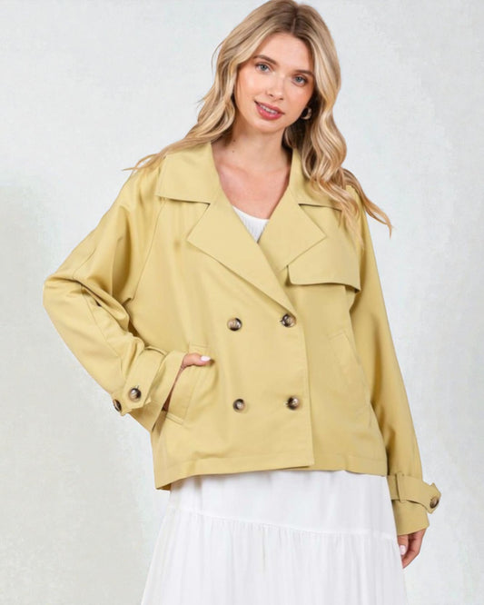 Woman wearing a yellow jacket with a white background