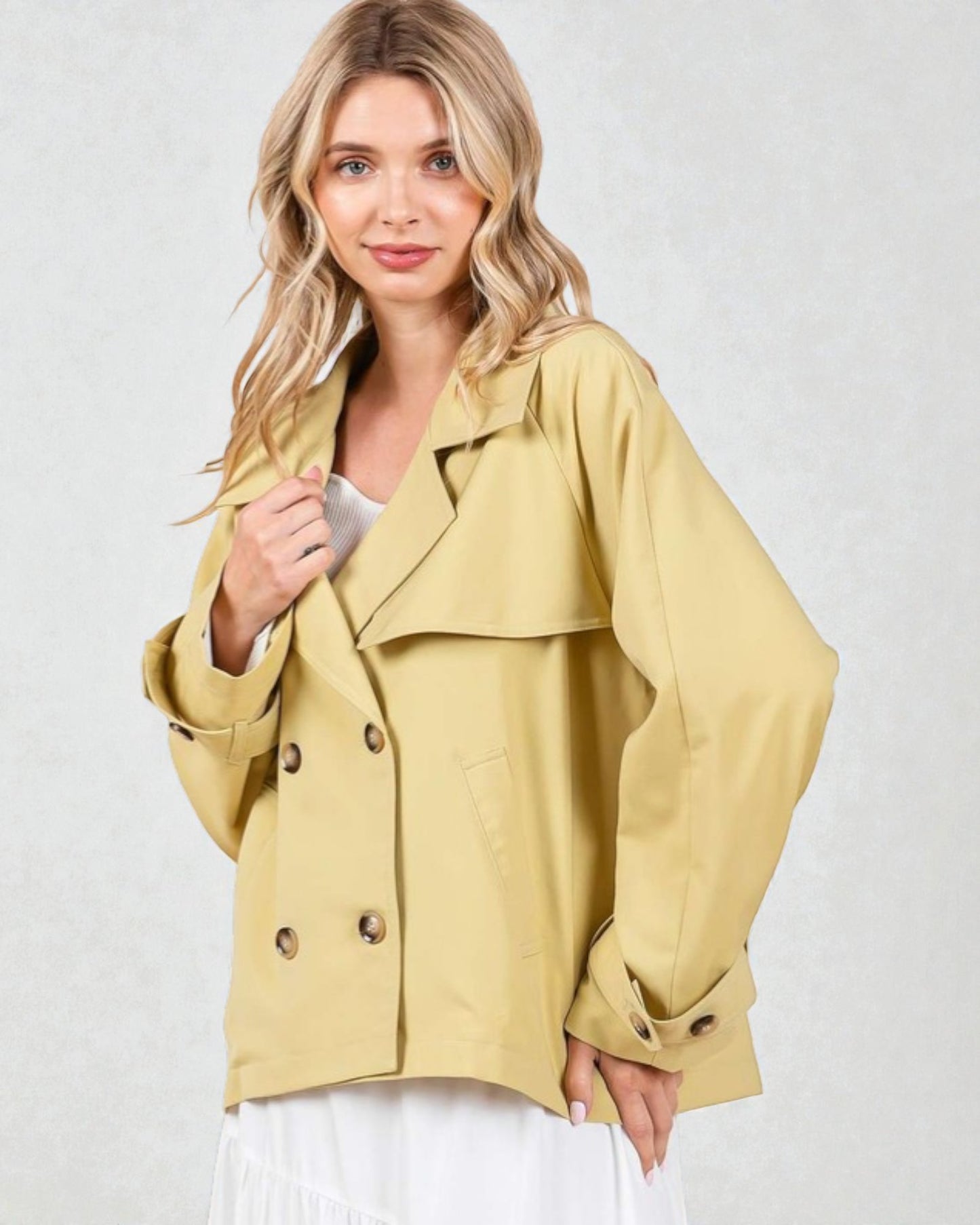 Woman wearing a yellow jacket on a white background