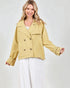 Woman wearing a mustard yellow jacket on a white background