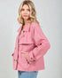 Woman wearing a pink jacket against a plain background