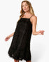 A woman modeling a black spaghetti-strap slip dress with a shaggy, feather-like textured fabric against a plain white studio background.
