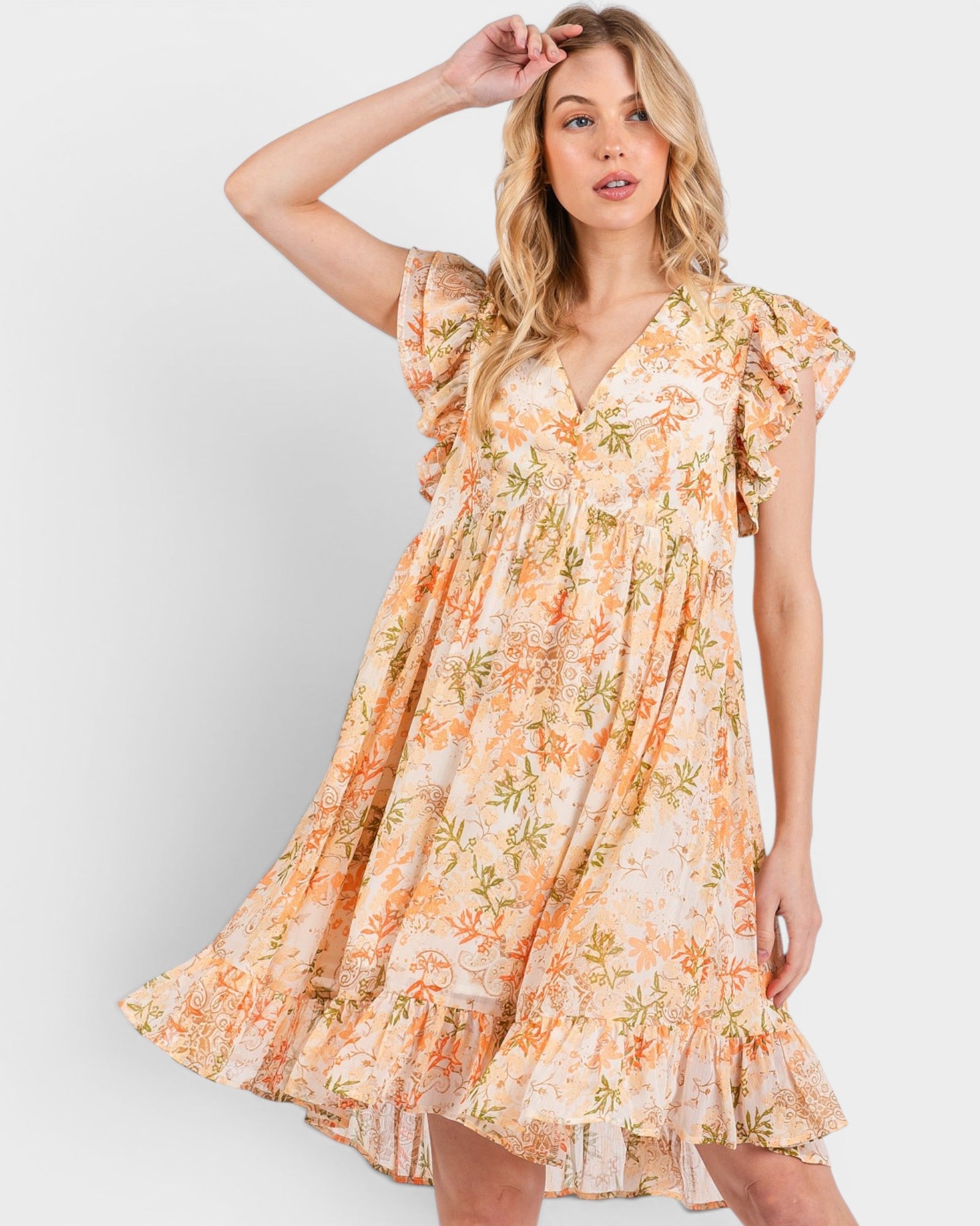 Woman wearing a floral dress on a plain background