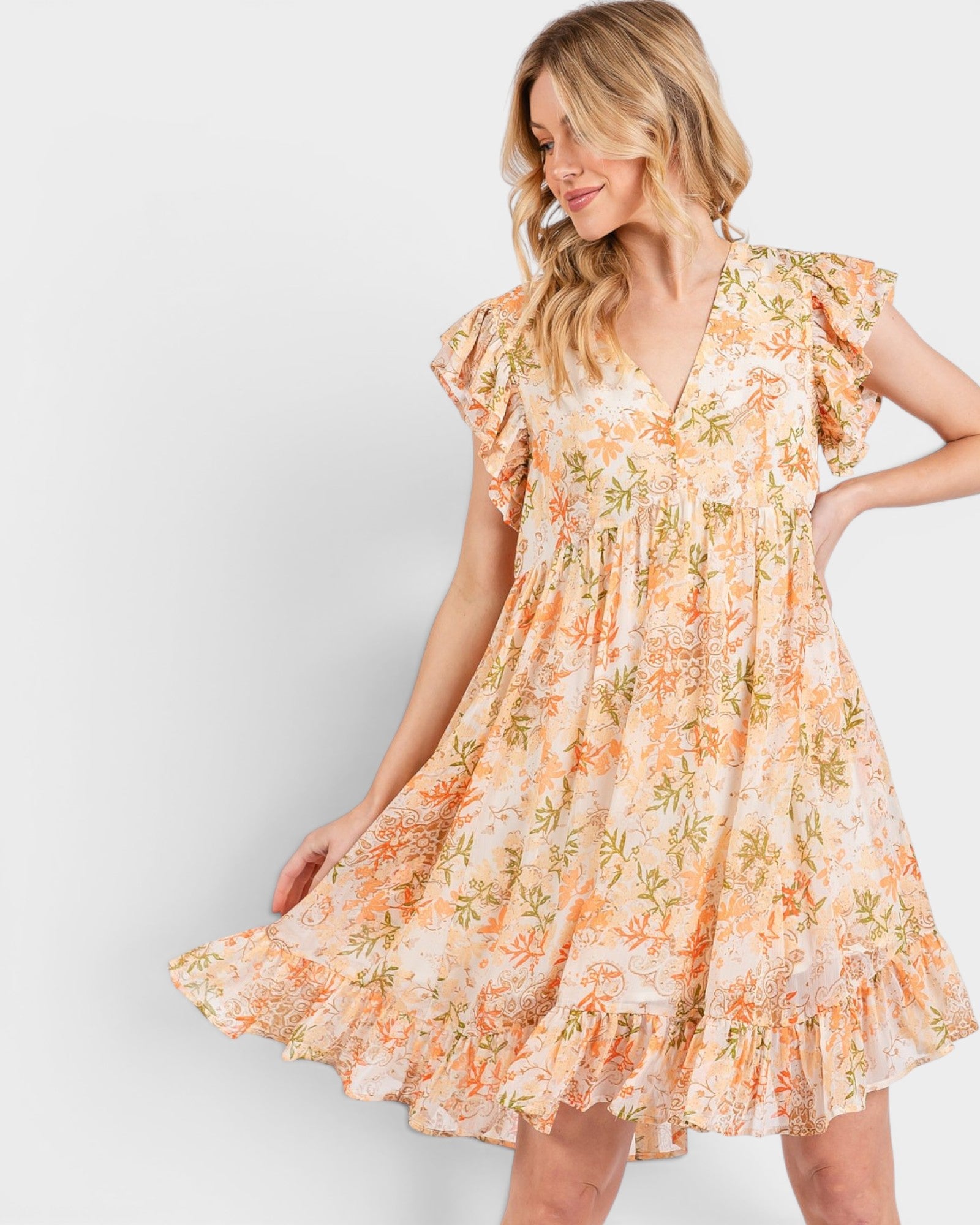 Woman wearing a floral dress with a plain background