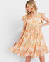 Woman wearing a floral dress with a plain background