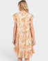 Woman wearing a floral dress with ruffled sleeves on a white background
