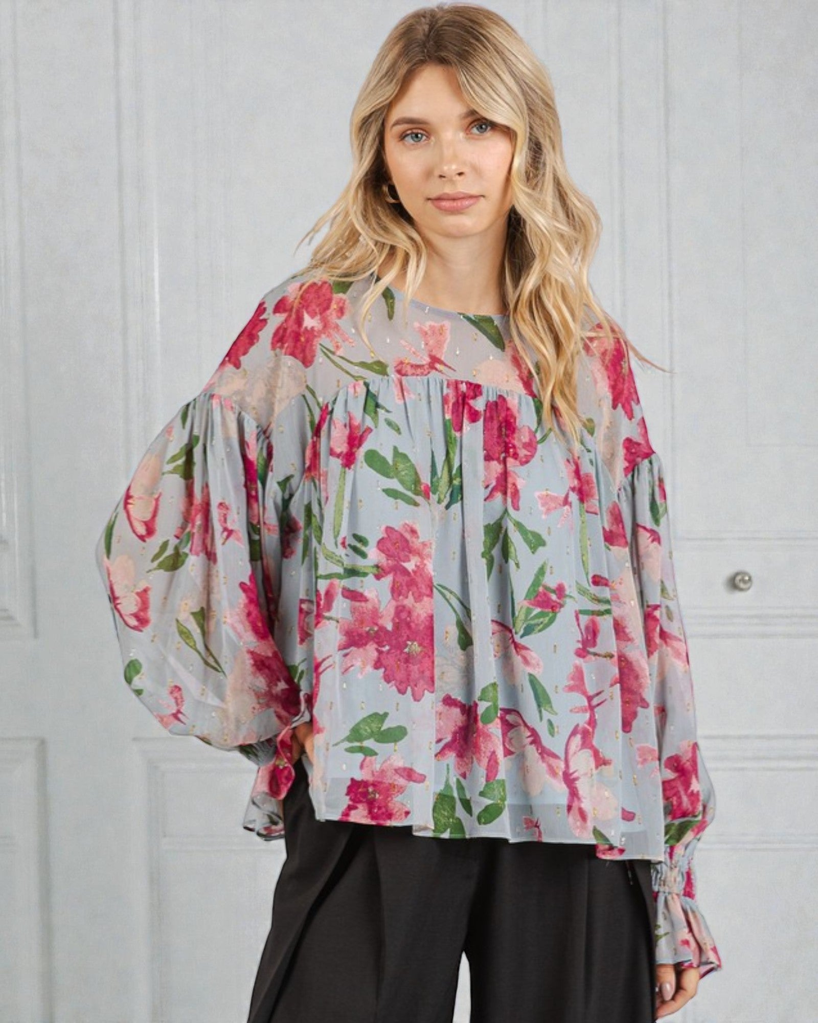 Woman wearing a floral blouse with a white background