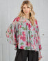 Woman wearing a floral blouse with a white background