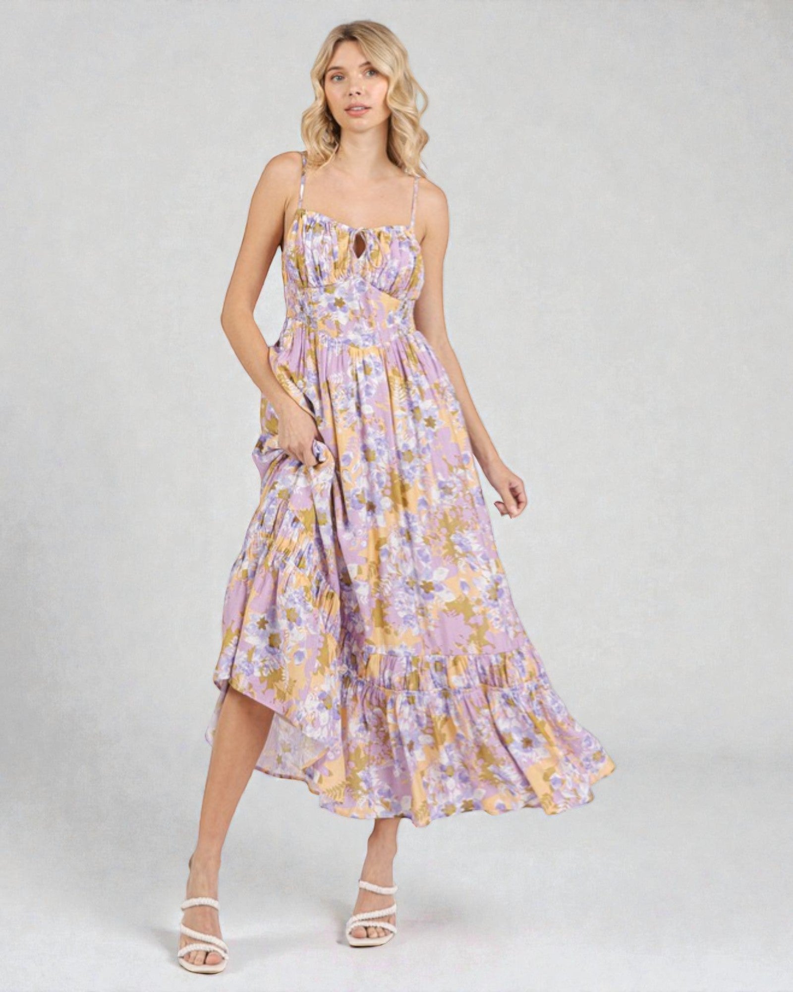 Woman wearing a floral dress on a plain background