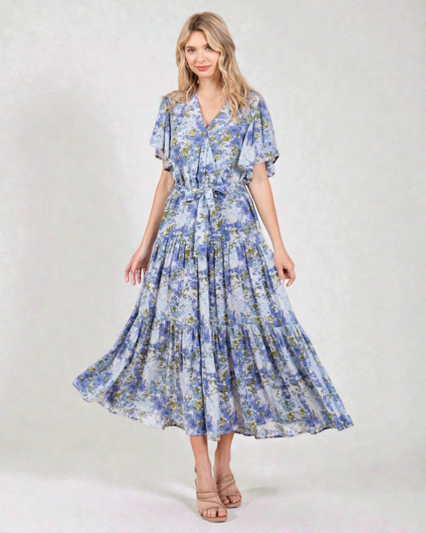 Woman wearing a blue floral dress on a white background
