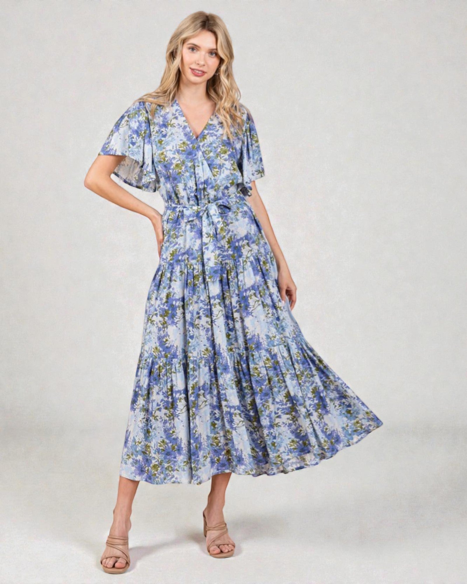 Woman wearing a blue floral dress on a white background