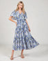 Woman wearing a blue floral dress on a white background