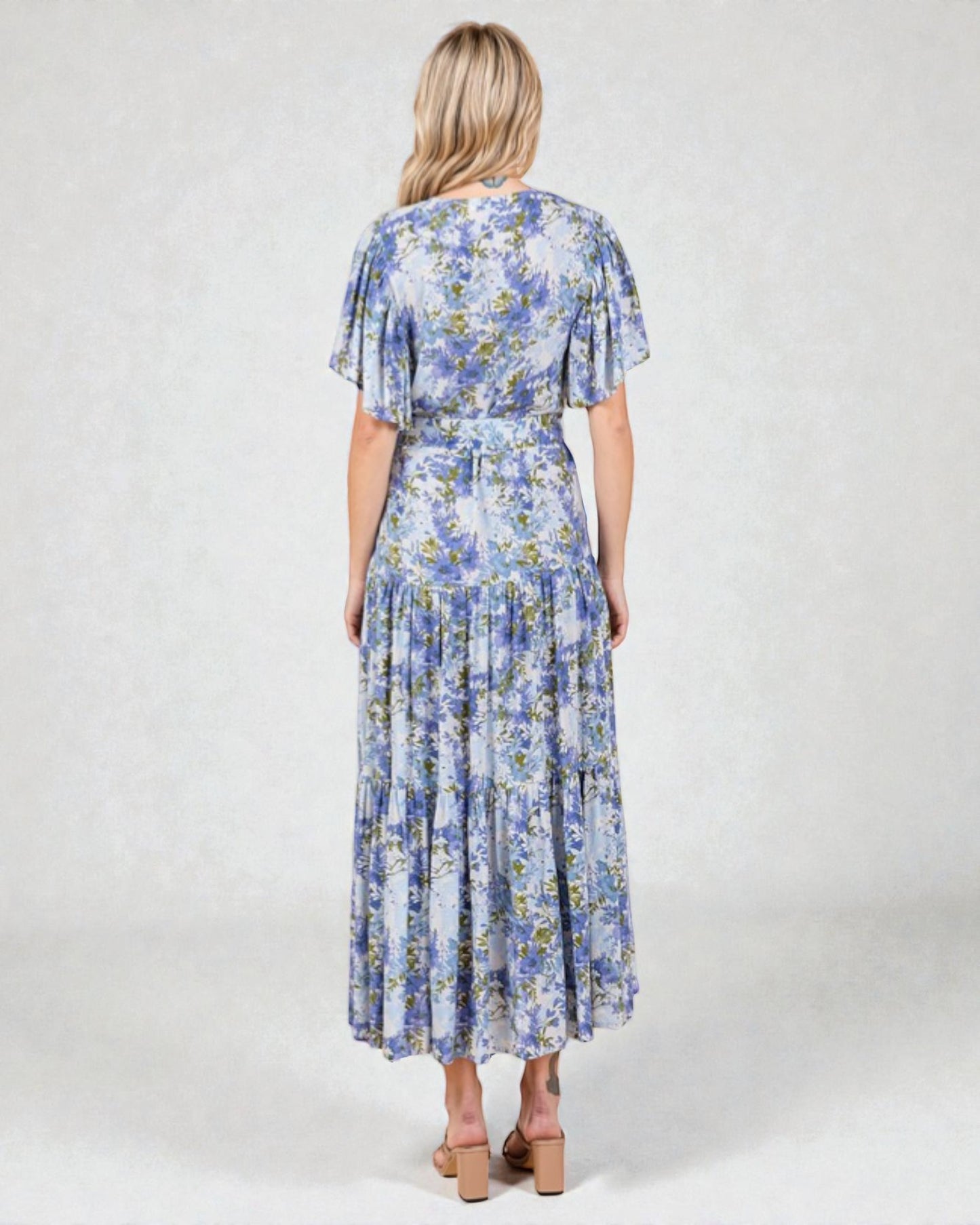 Woman wearing a blue floral dress on a white background