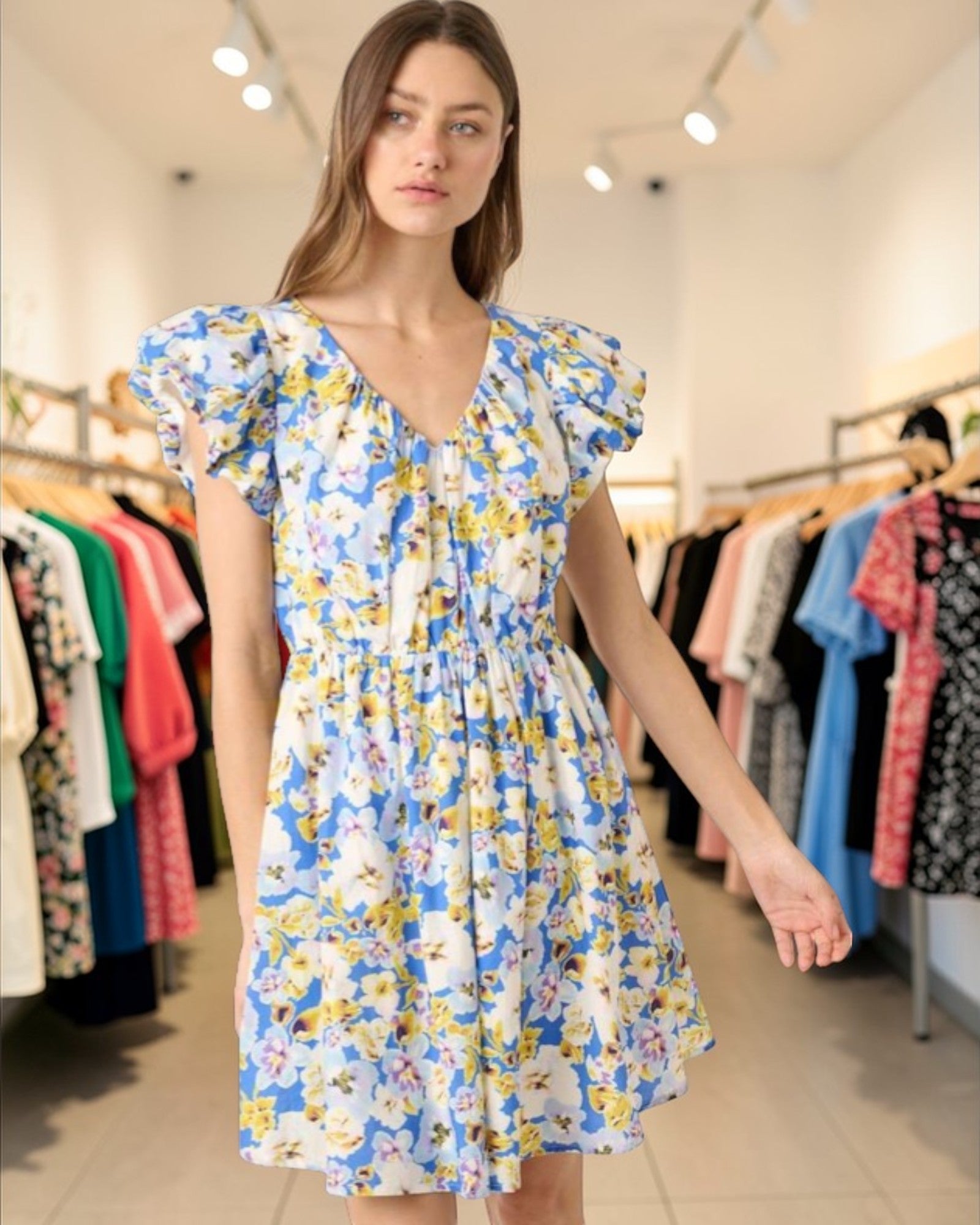 Woman wearing a floral dress in a clothing store