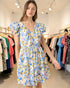 Woman wearing a floral dress in a clothing store