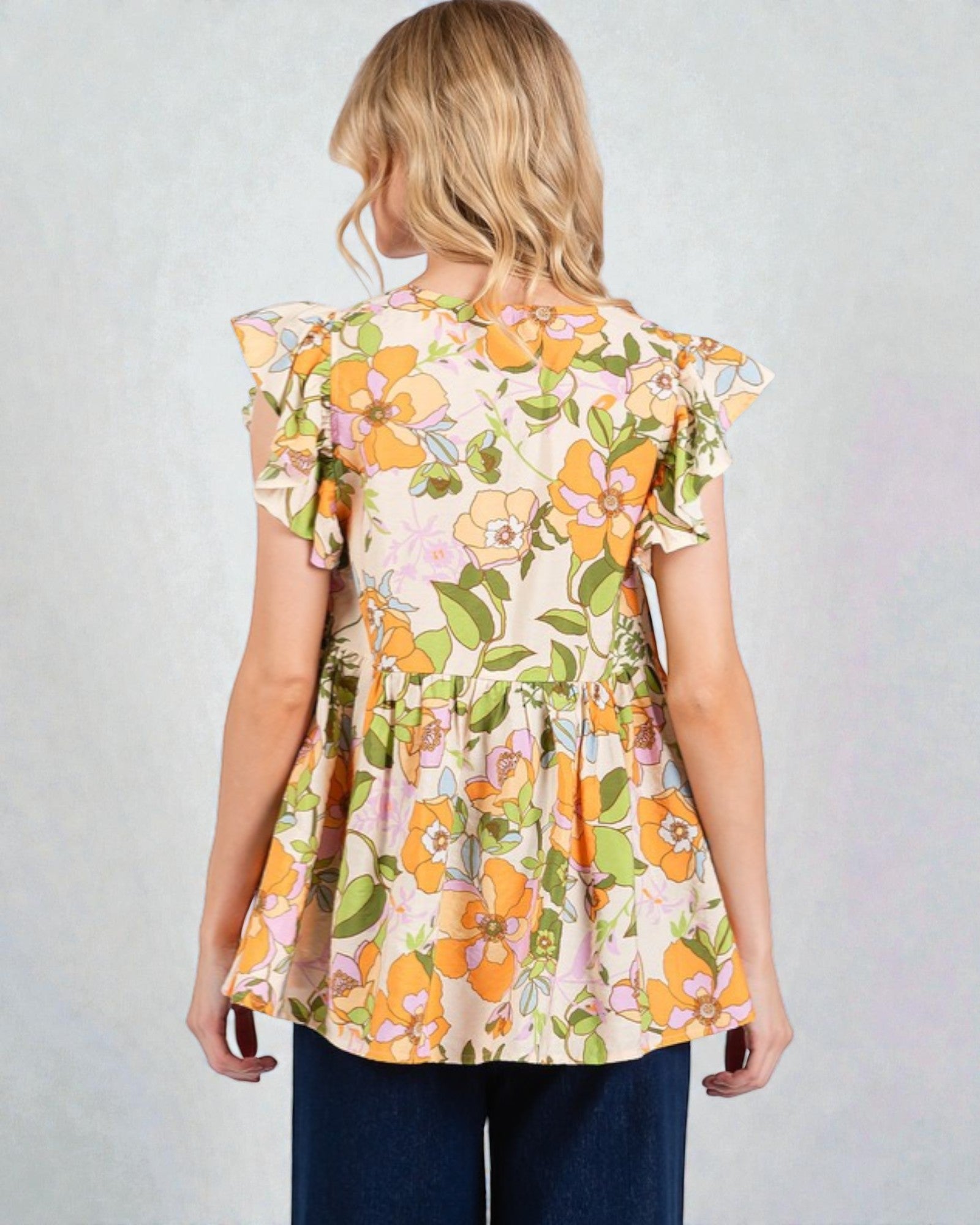 Woman wearing a floral blouse with a plain background