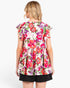 A woman shown from the back wearing a short-sleeve floral peplum top with black shorts, against a plain white studio background.