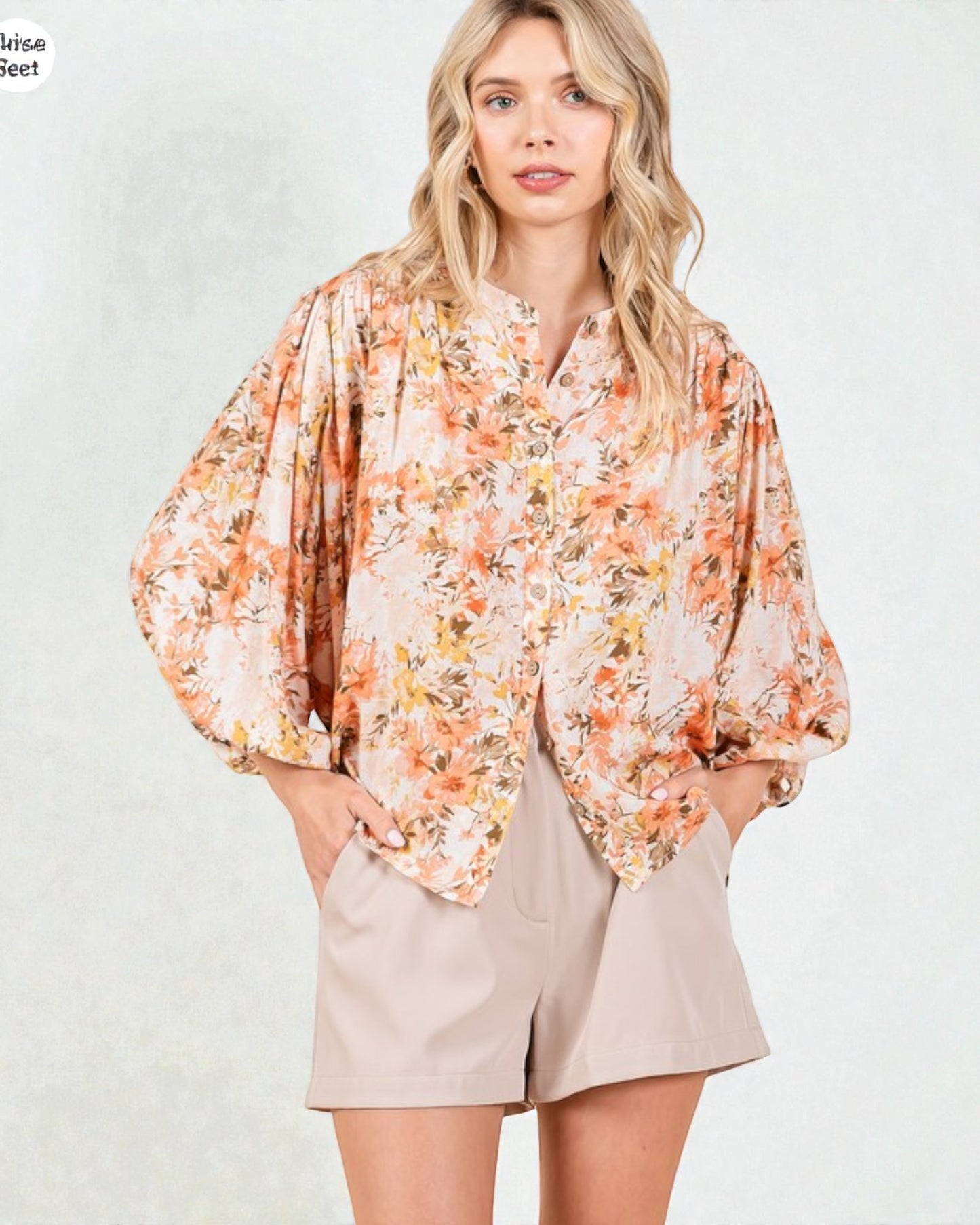 Woman wearing a floral scarf with a plain background