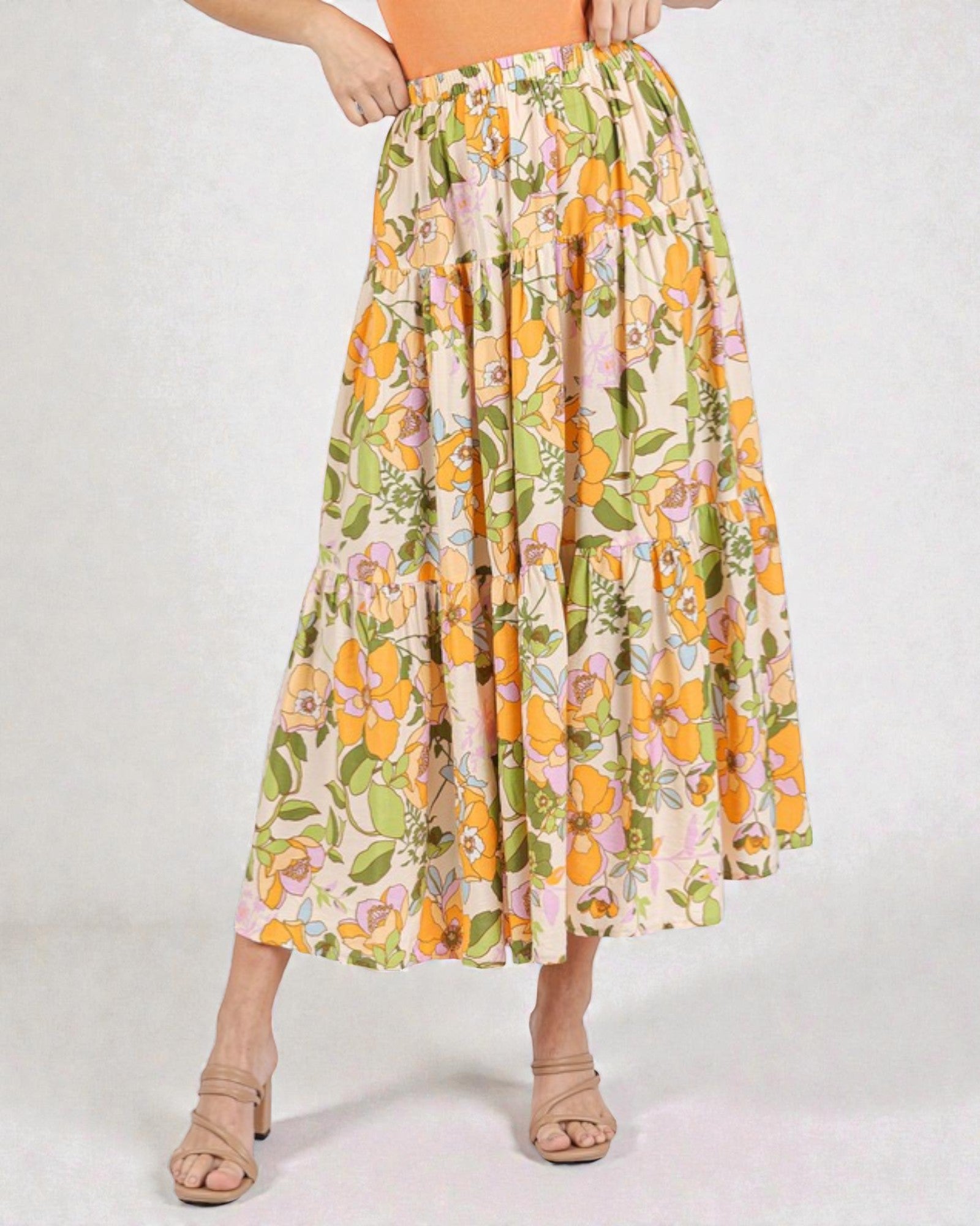 Floral patterned skirt worn by a person on a white background