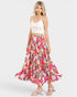 Woman wearing a floral skirt and white top on a white background
