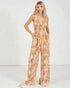 Woman wearing a floral jumpsuit on a white background