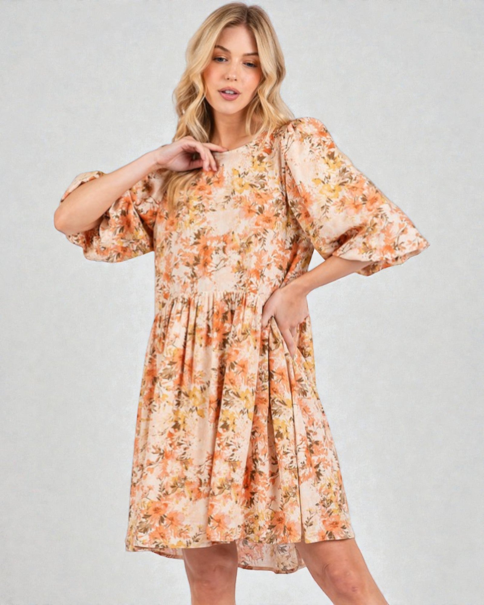 Woman wearing a floral dress on a plain background