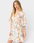 Woman wearing a floral dress on a white background