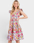 Woman wearing a colorful floral dress on a white background
