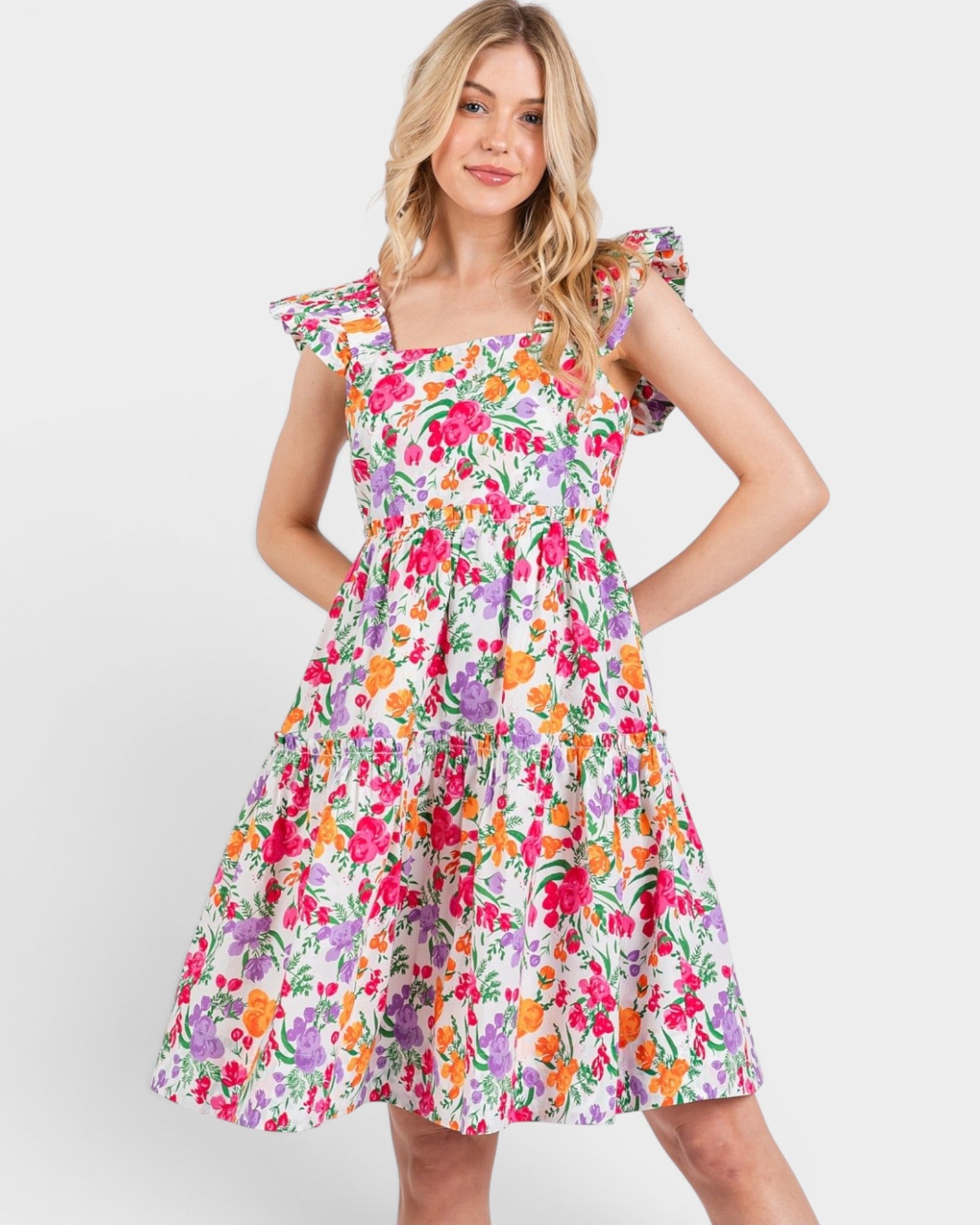 Woman wearing a colorful floral dress on a white background