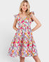 Woman wearing a colorful floral dress on a white background