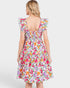 Woman wearing a colorful floral dress on a white background