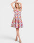 Woman wearing a colorful floral dress on a white background
