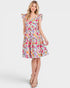 Woman wearing a colorful floral dress on a white background