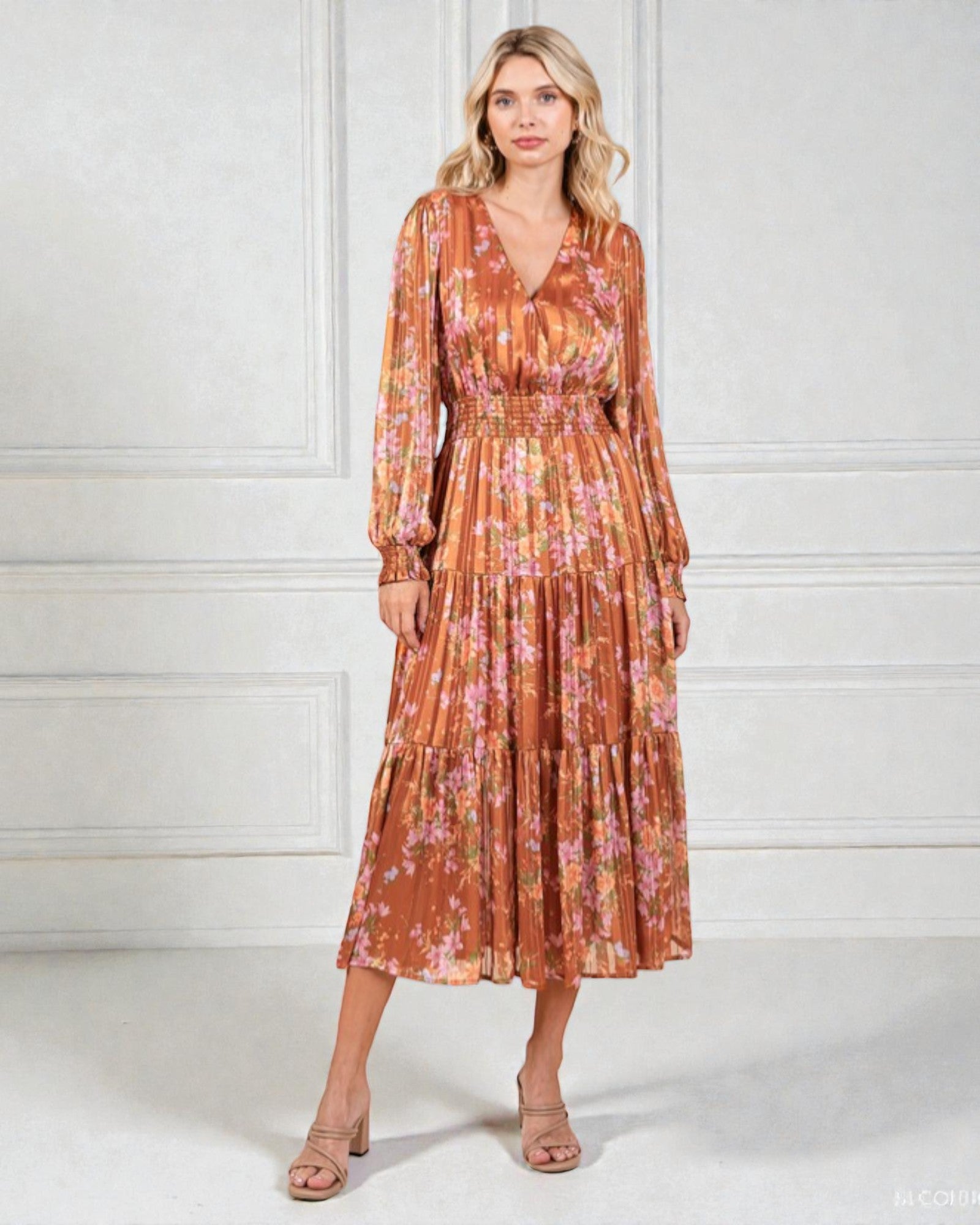 Woman wearing a floral dress against a white background