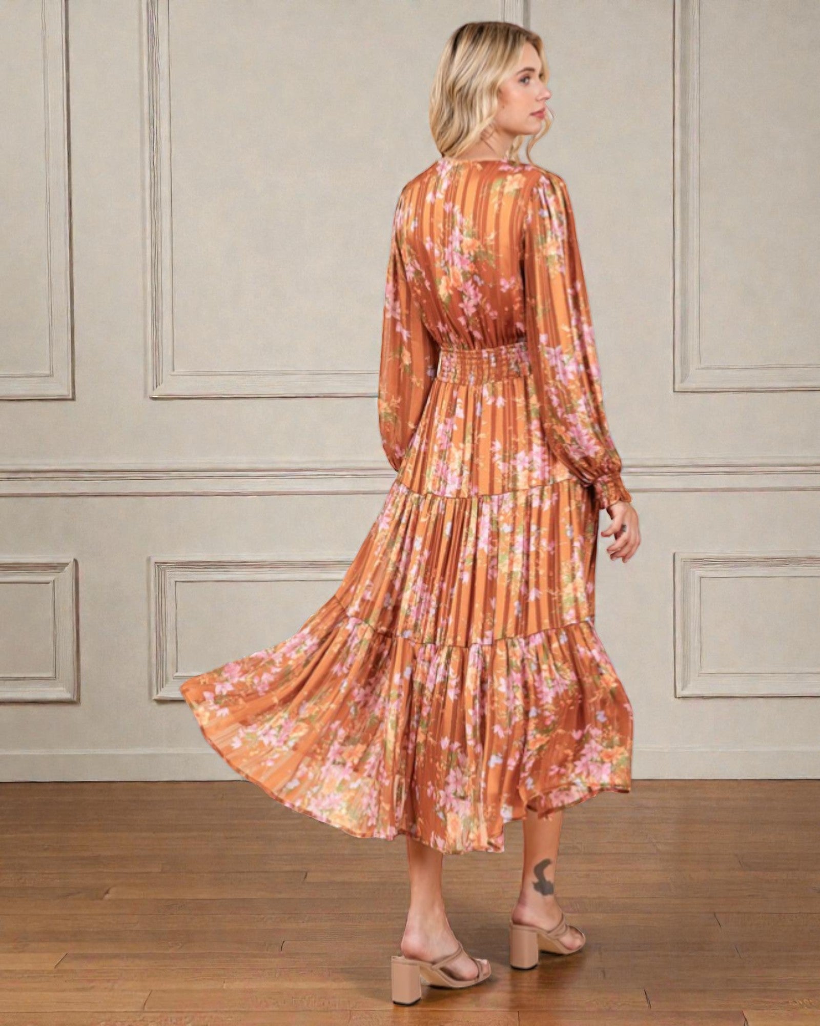 Woman wearing a floral dress with a neutral background