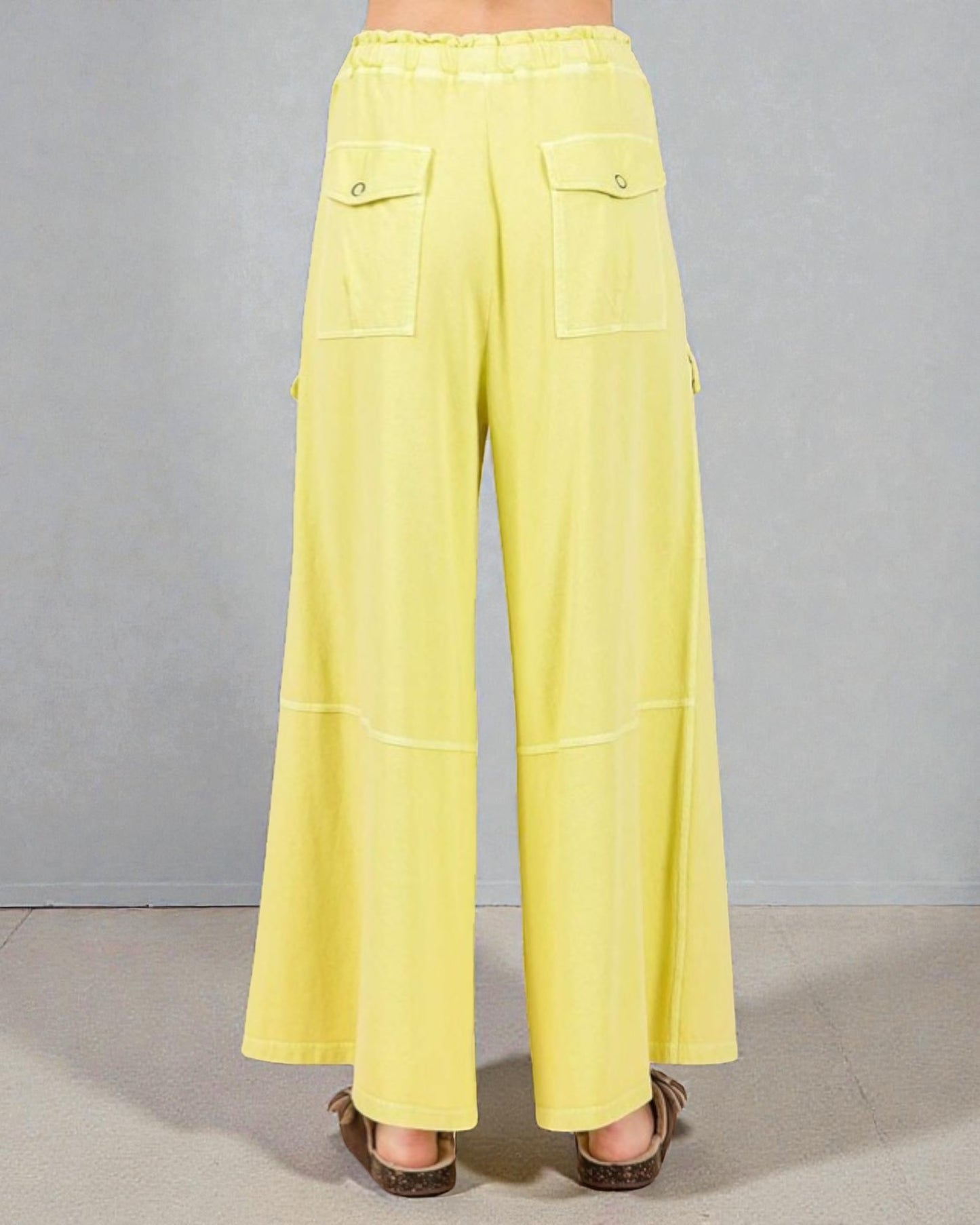 Yellow wide-leg pants on a neutral background