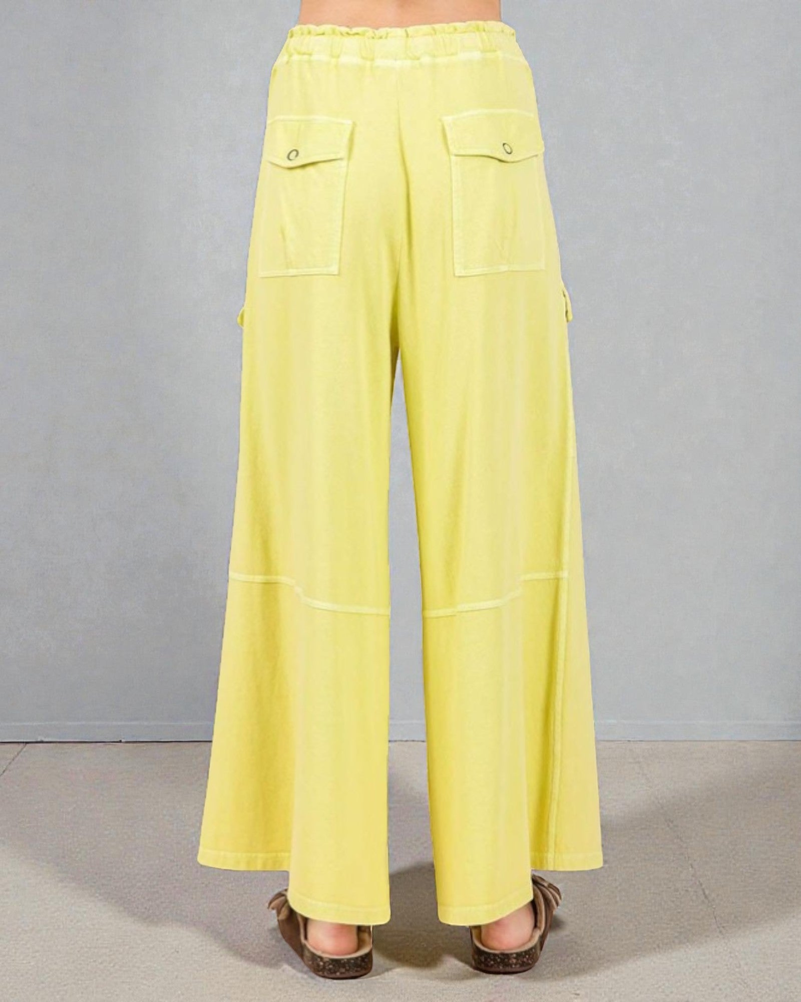 Yellow wide-leg pants on a neutral background