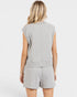 Woman wearing a gray sleeveless top and shorts set on a white background