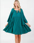 Woman wearing a teal dress on a white background